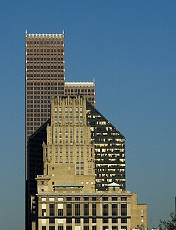 Three skyscrapers visually overlap each other. The simple, rectangular tiers of JPMorgan Chase Building contrast with the five-sided tower of the Pennzoil building and the stepped rows of spires of the Bank of America building.