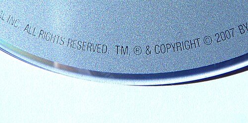 Text engraved on a DVD: ...ALL RIGHTS RESERVED, TM, ® & COPYRIGHT © 2007 BY...